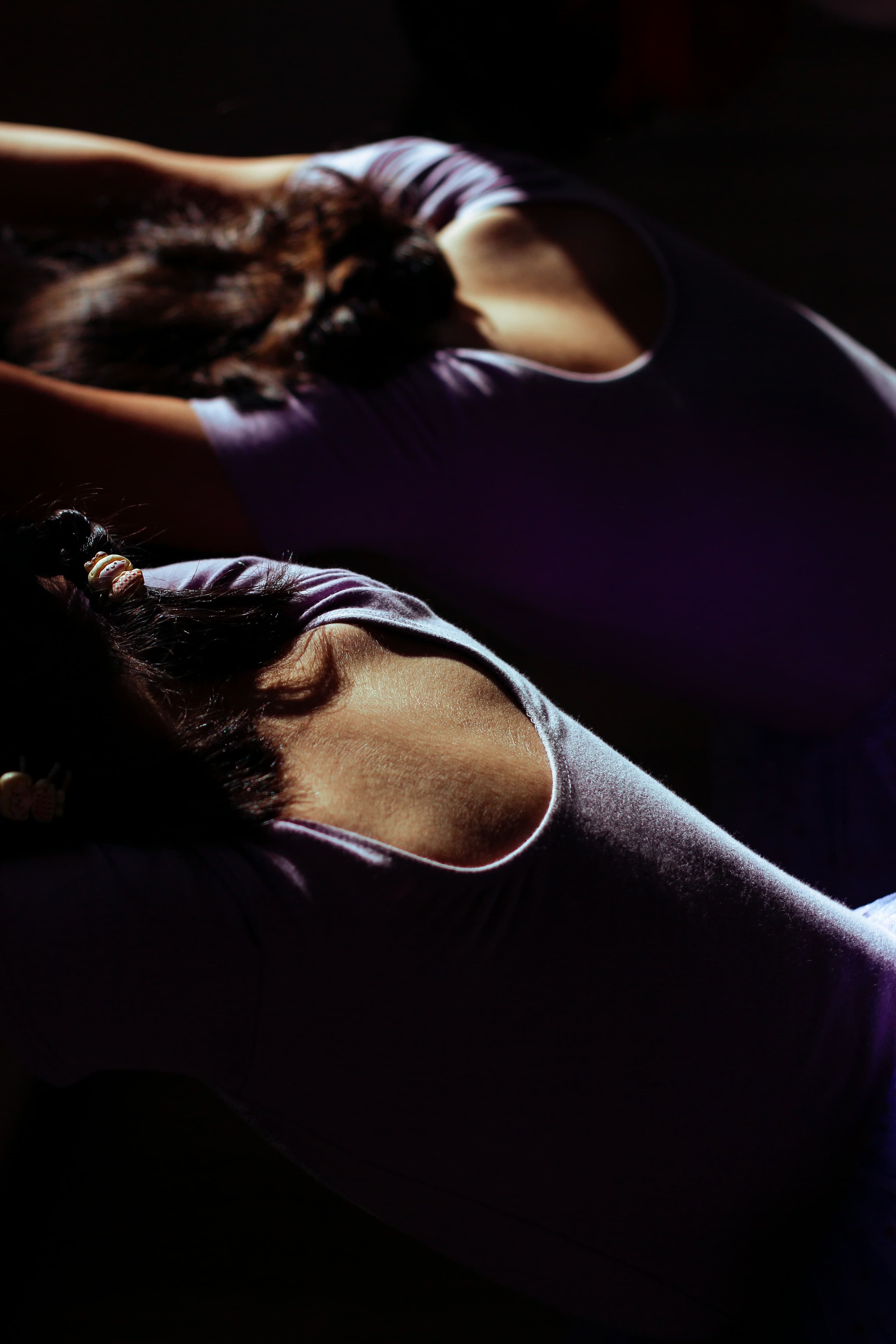 Two clients training together during a duet Pilates session